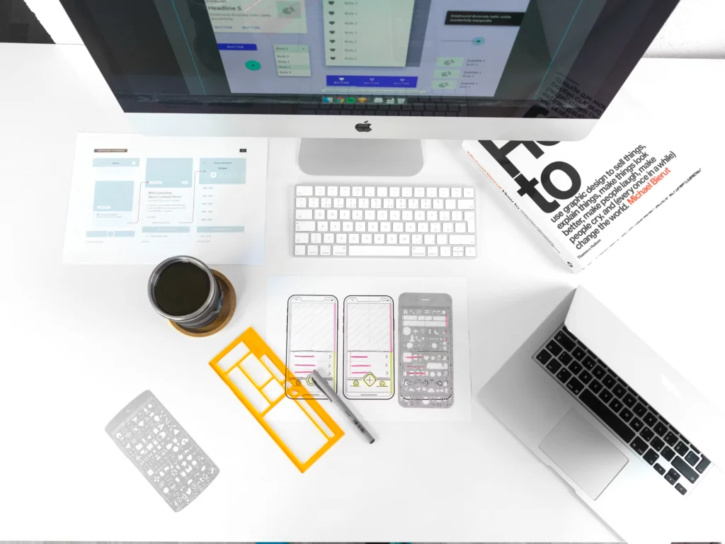 Top-down aerial photograph of a UX designer’s desk with tools and work materials