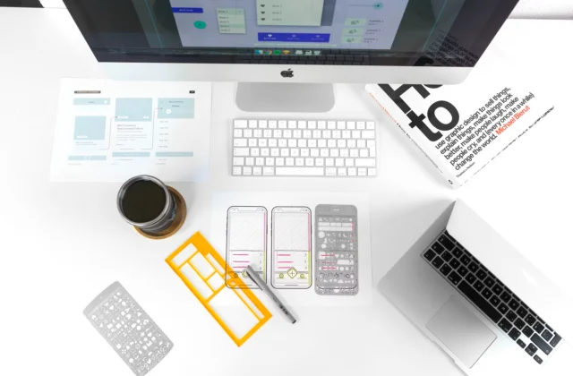 Top-down aerial photograph of a UX designer’s desk with tools and work materials