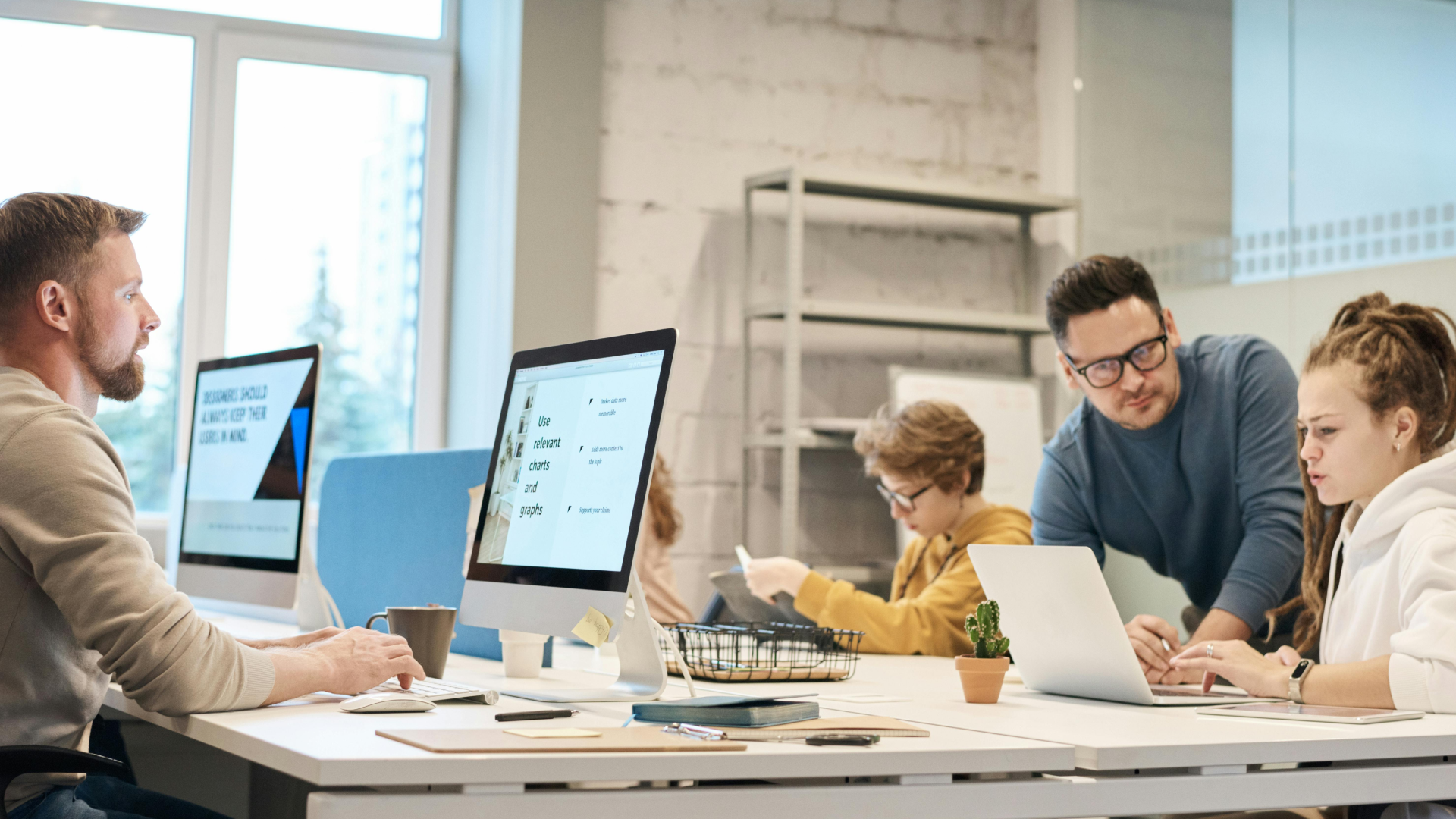 UX contractors working at their desks in a collaborative office environment